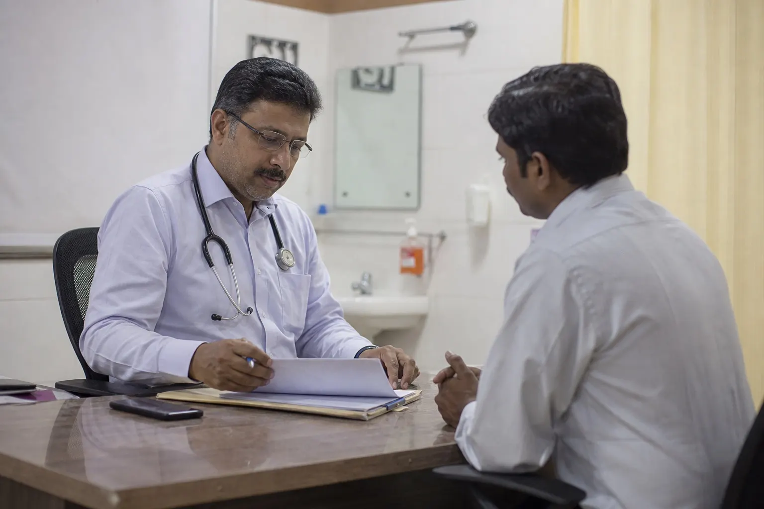 General physician reviewing a patient during consultation